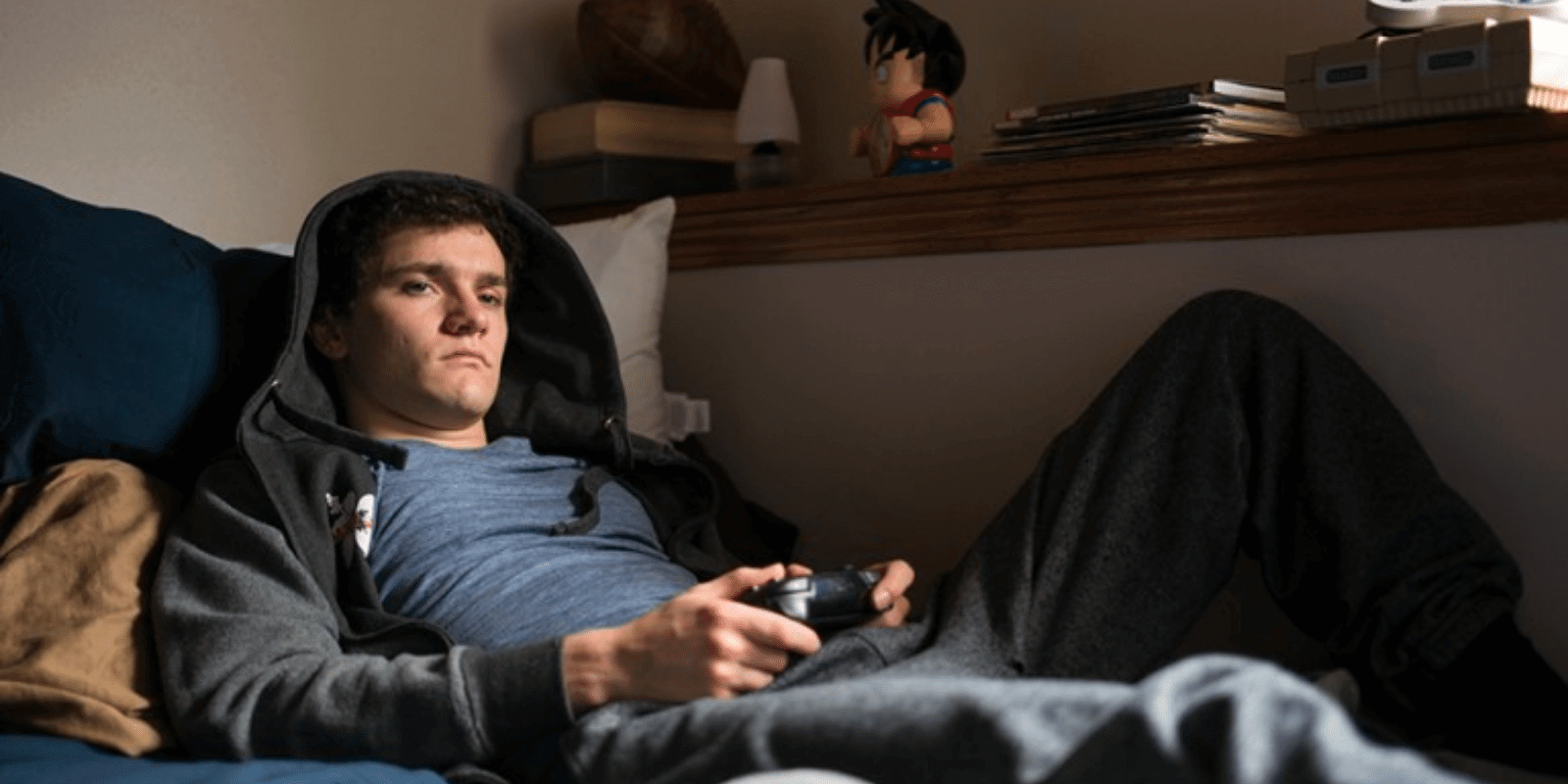Teen boy in the bed playing video games