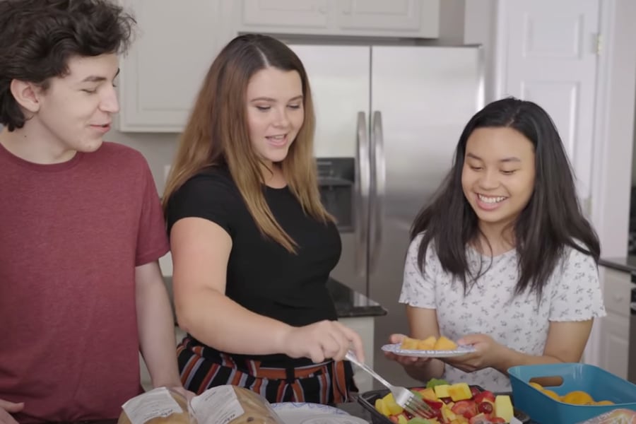 teens getting food in kitchen