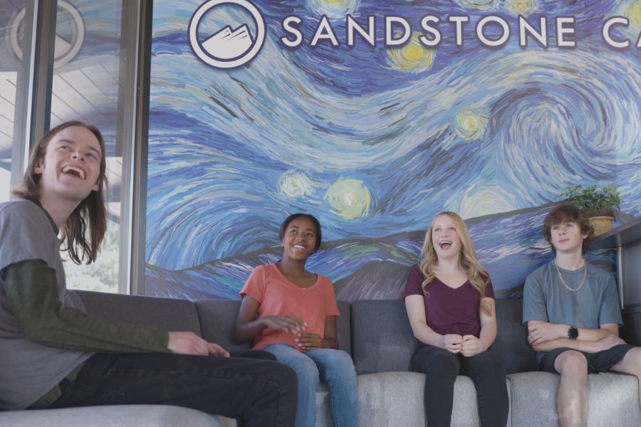 teens sitting in treatment waiting room smiling