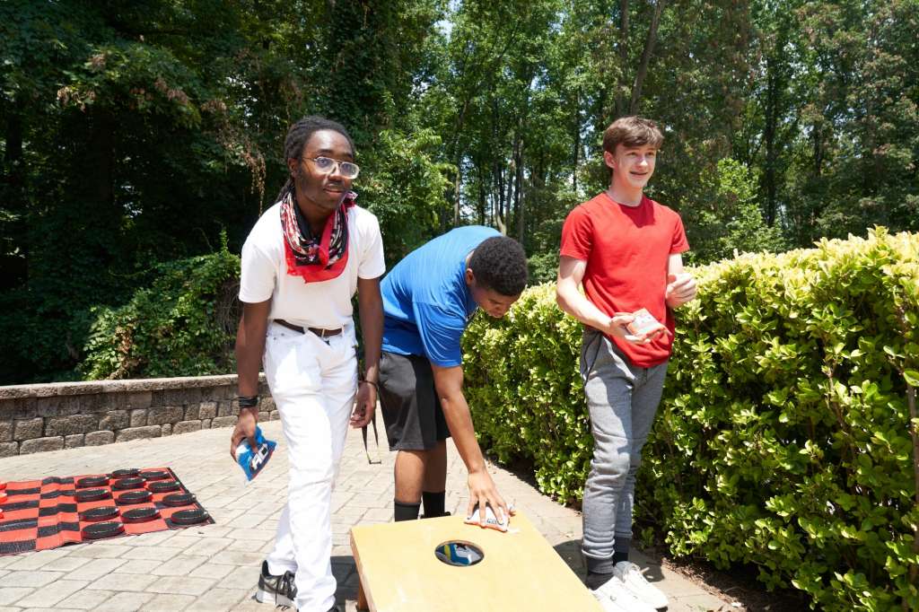 Teens doing bean bag toss activity at Chesapeake teen rehab center