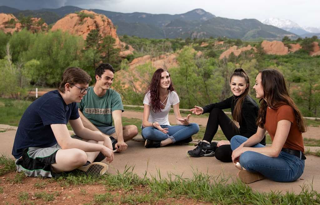 Group therapy discussion outdoors at Colorado teen rehab