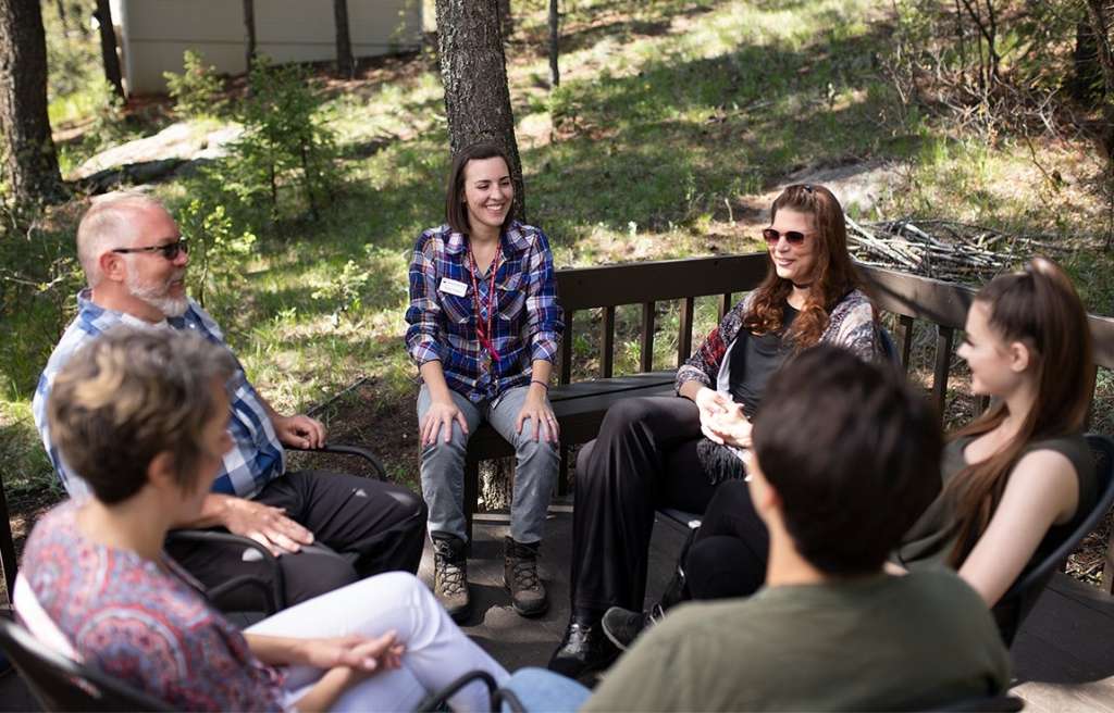 Group discussion on patio with therapist at Colorado teen rehab