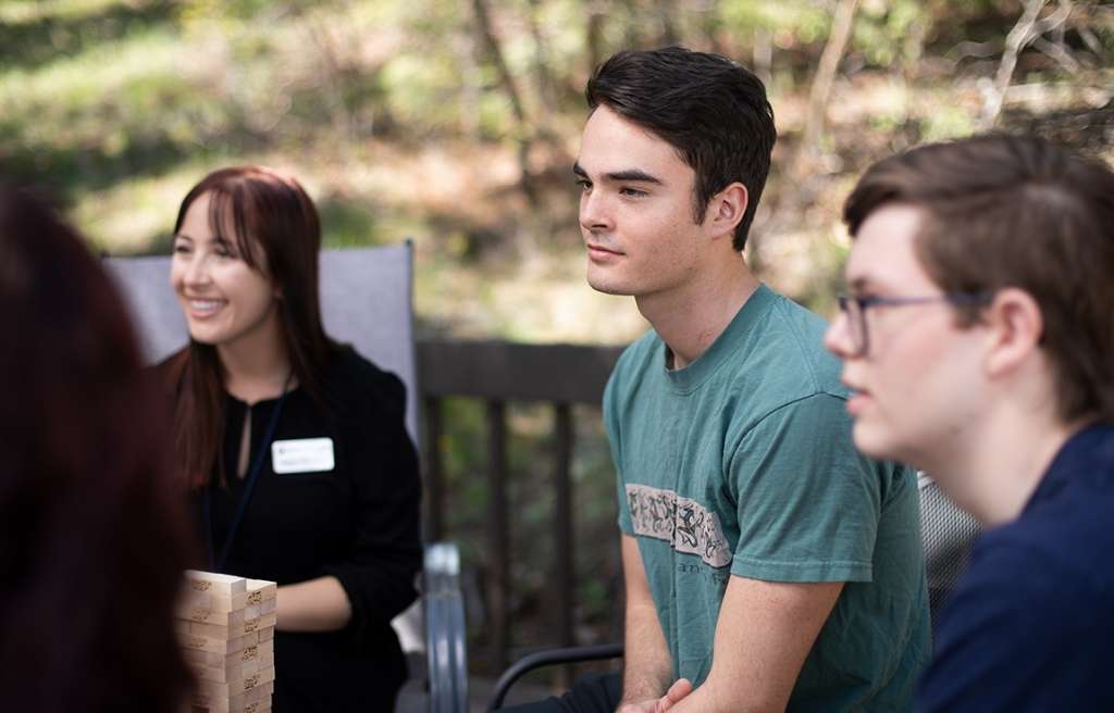 Teen group therapy session on outdoor patio at Colorado teen rehab