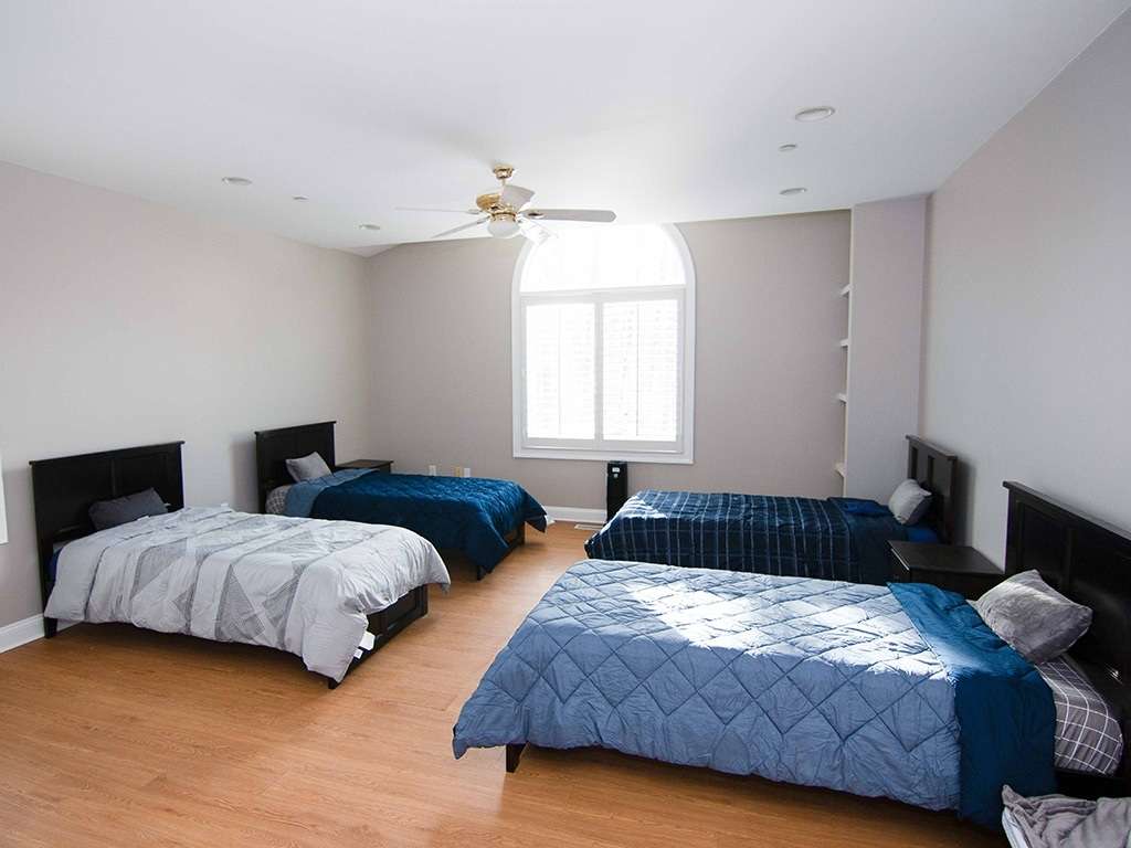 Chesapeake teen rehab center bedroom area with 4 beds with cozy blankets in blue colors