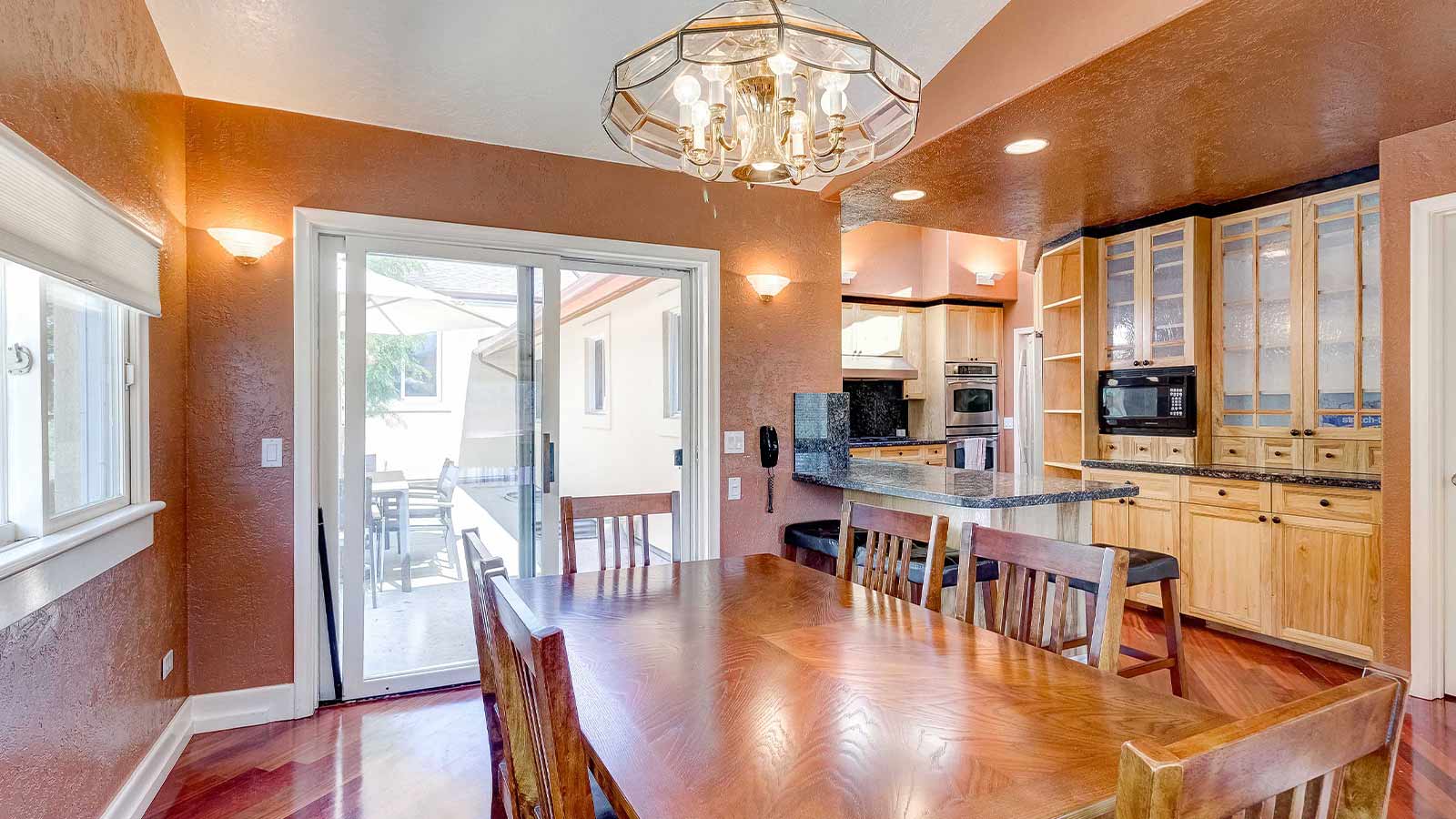 A warm and inviting dining adjacent to a modern kitchen.