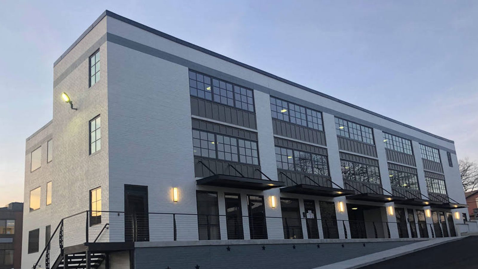 A modern white building with large windows.