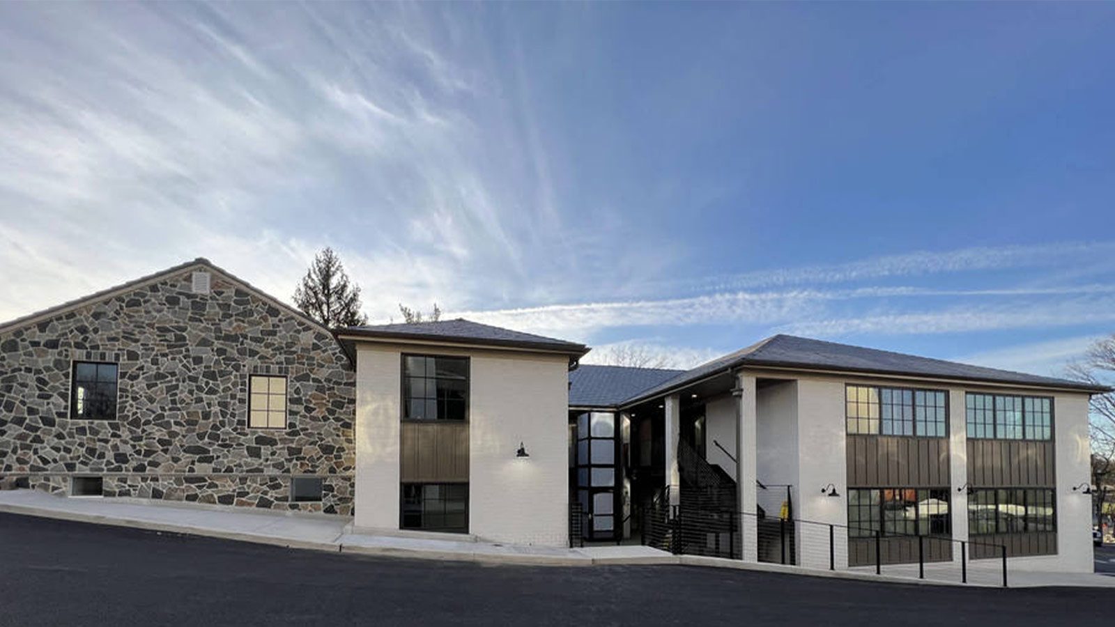 A modern rehabilitation center with a mix of stone and white-painted buildings.