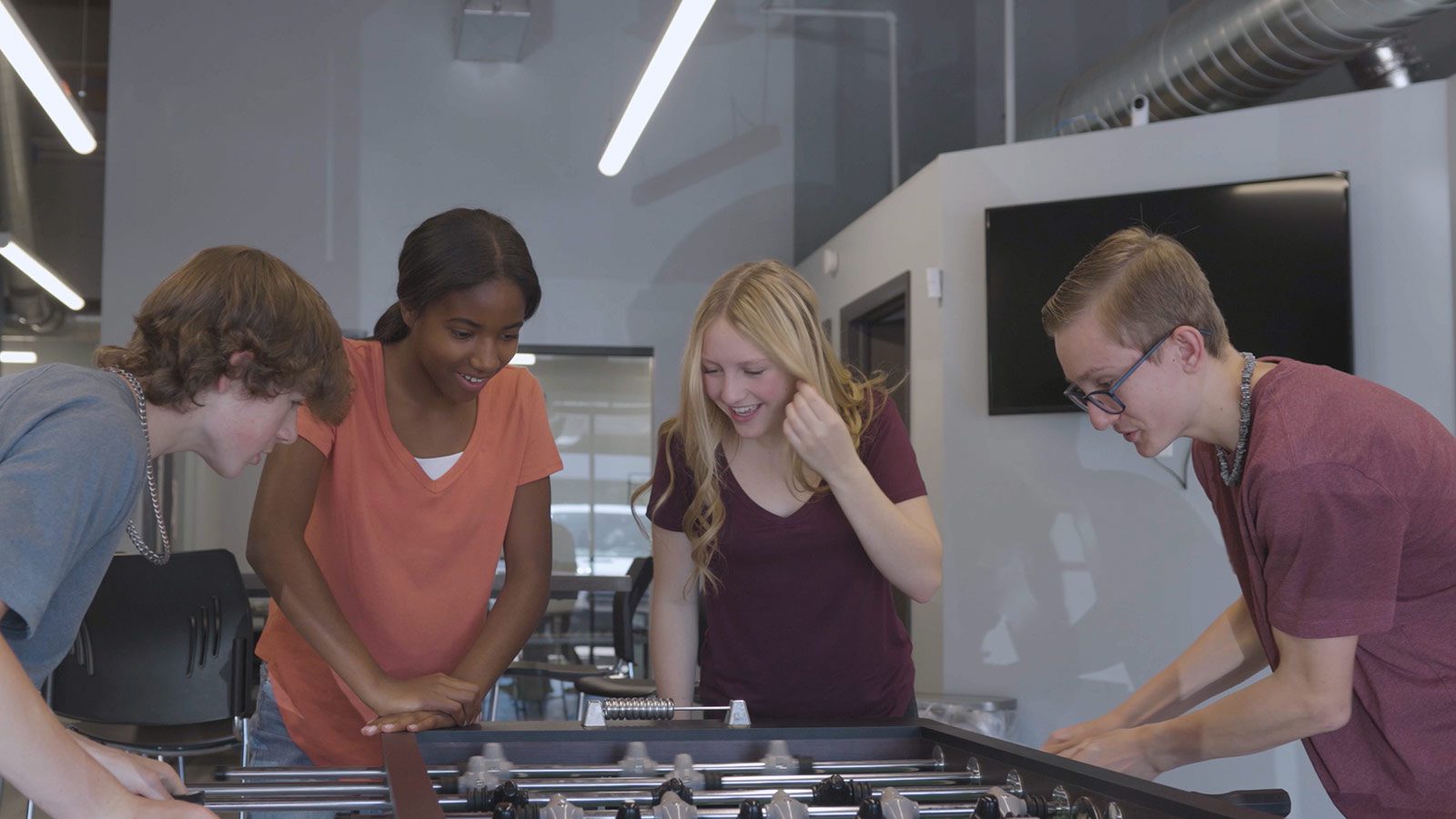 three young people playing a game of foo foo foo foo foo foo foo foo foo foo foo foo