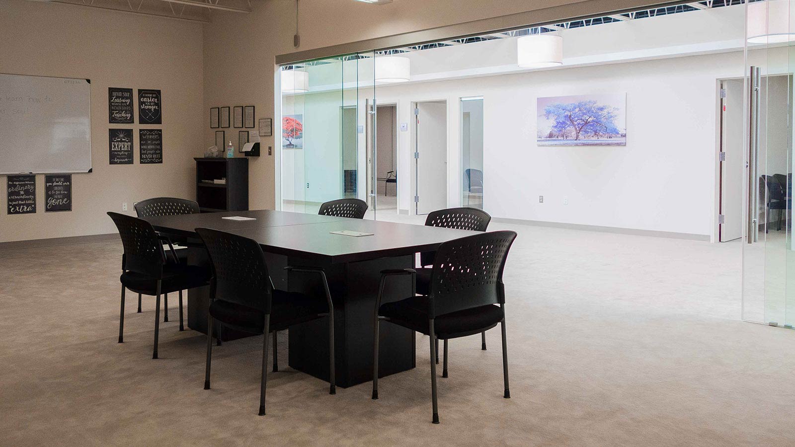 there is a large table and chairs in a room with a whiteboard