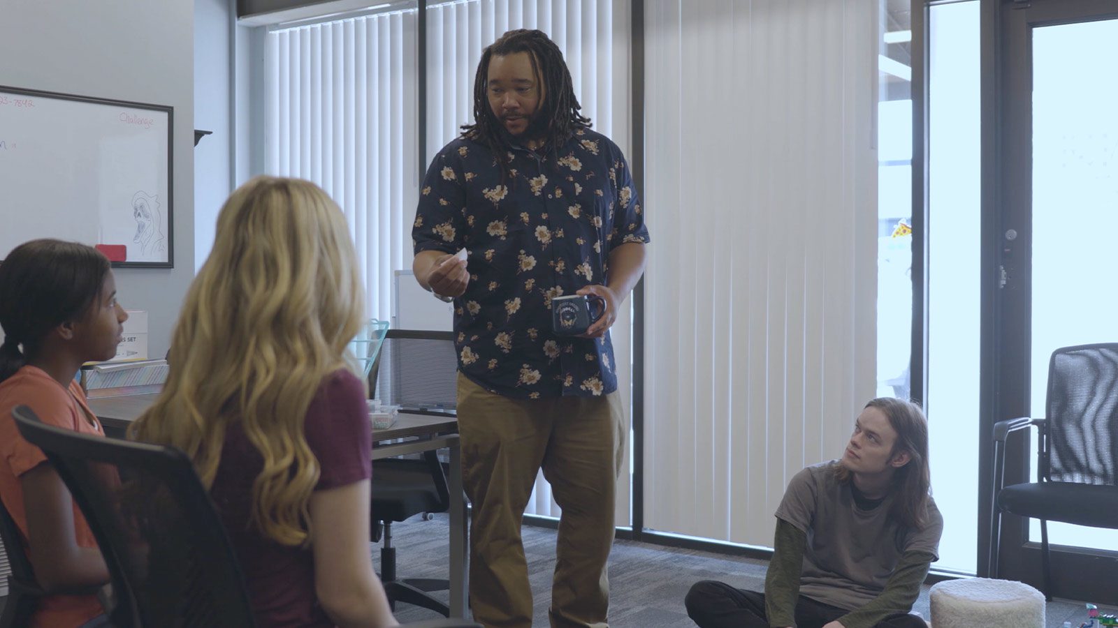 An instructor engaging with attentive therapy participants in a group setting.