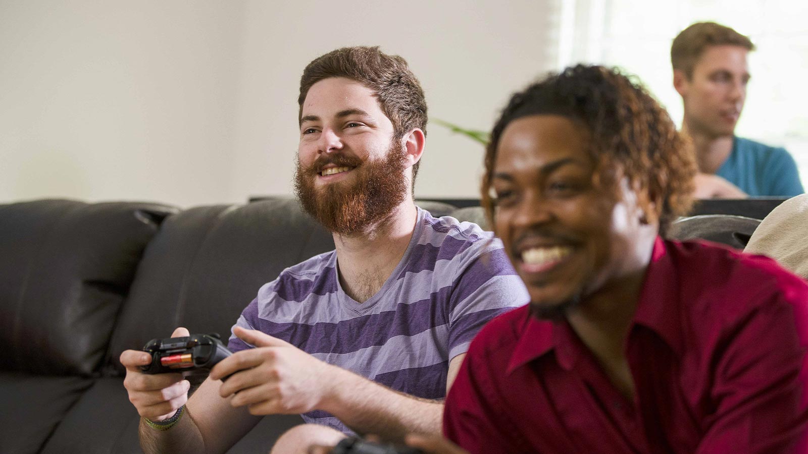 Two men playing video games on a couch.