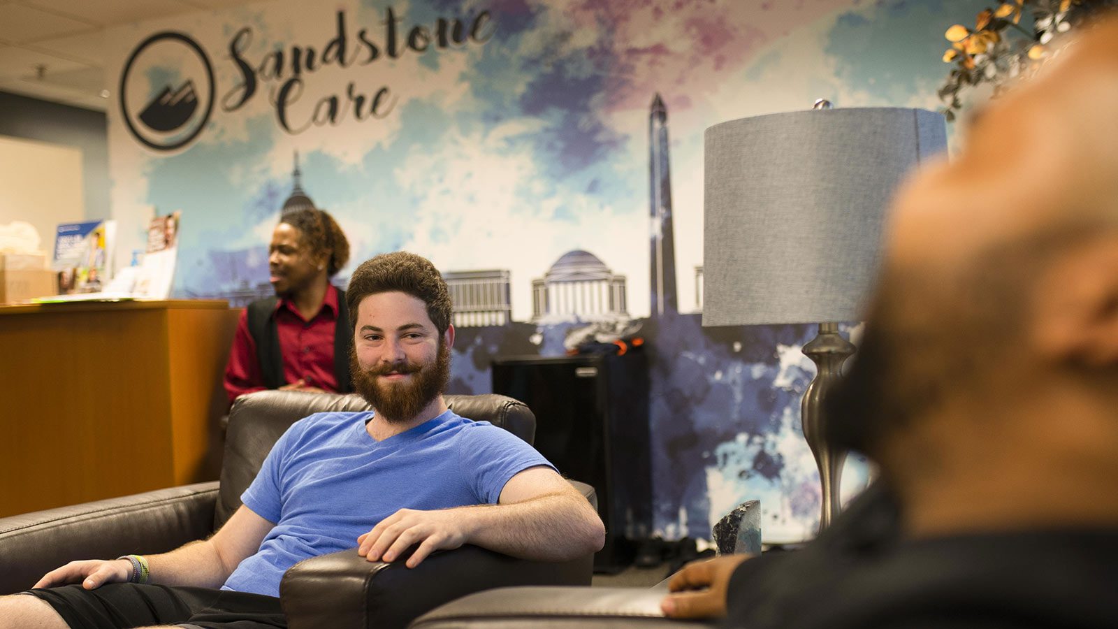 A waiting area with individuals engaged in a happy conversation.