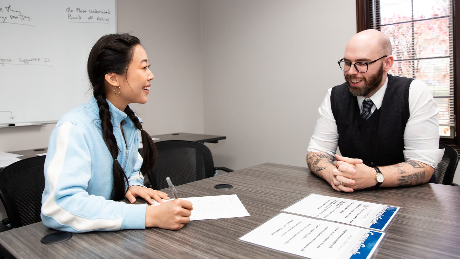 A one-on-one academic meeting with two people.