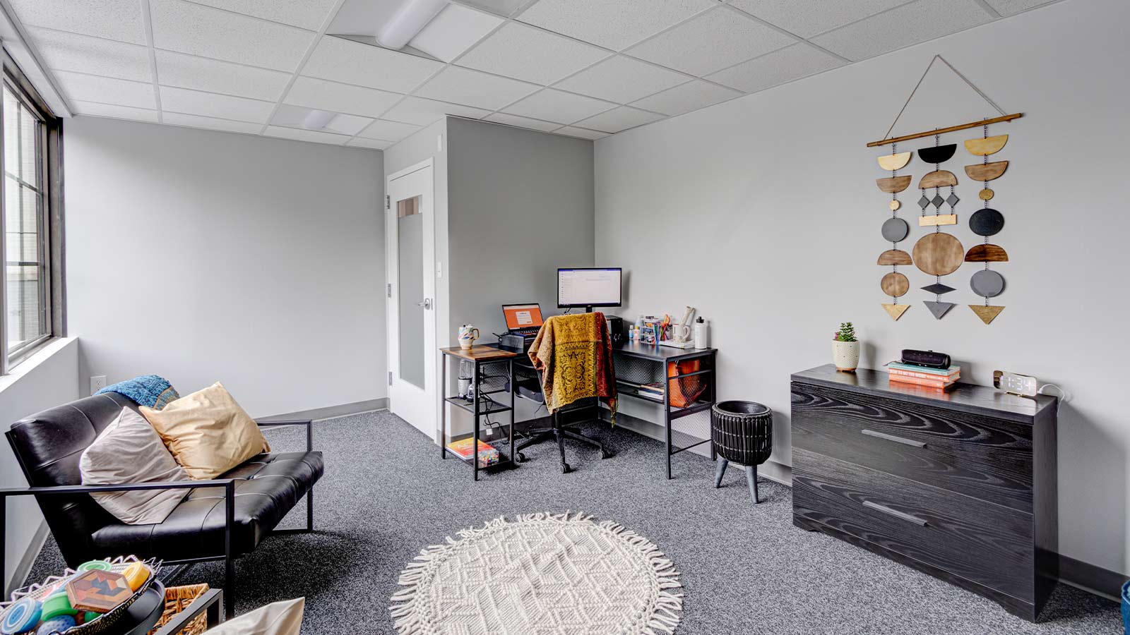 there is a room with a desk, chair, and a dresser