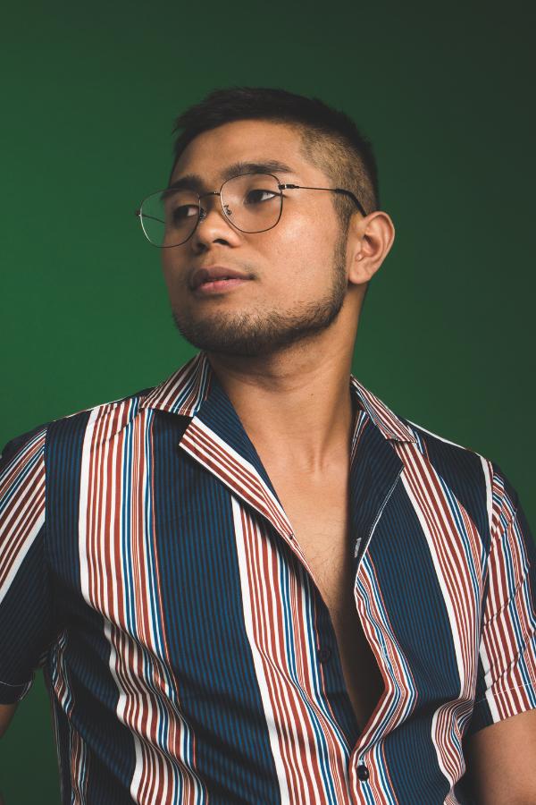 arafed man wearing glasses and a striped shirt looking up