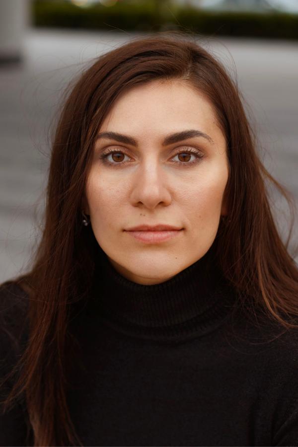 arafed woman with long brown hair and a black turtle neck sweater