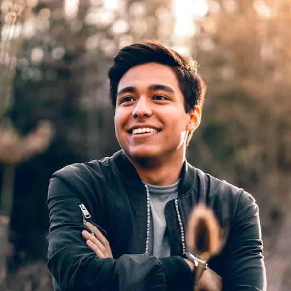 arafed man with a black jacket and a smile on his face