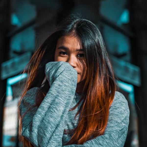 arafed woman with long hair covering her face with her hands