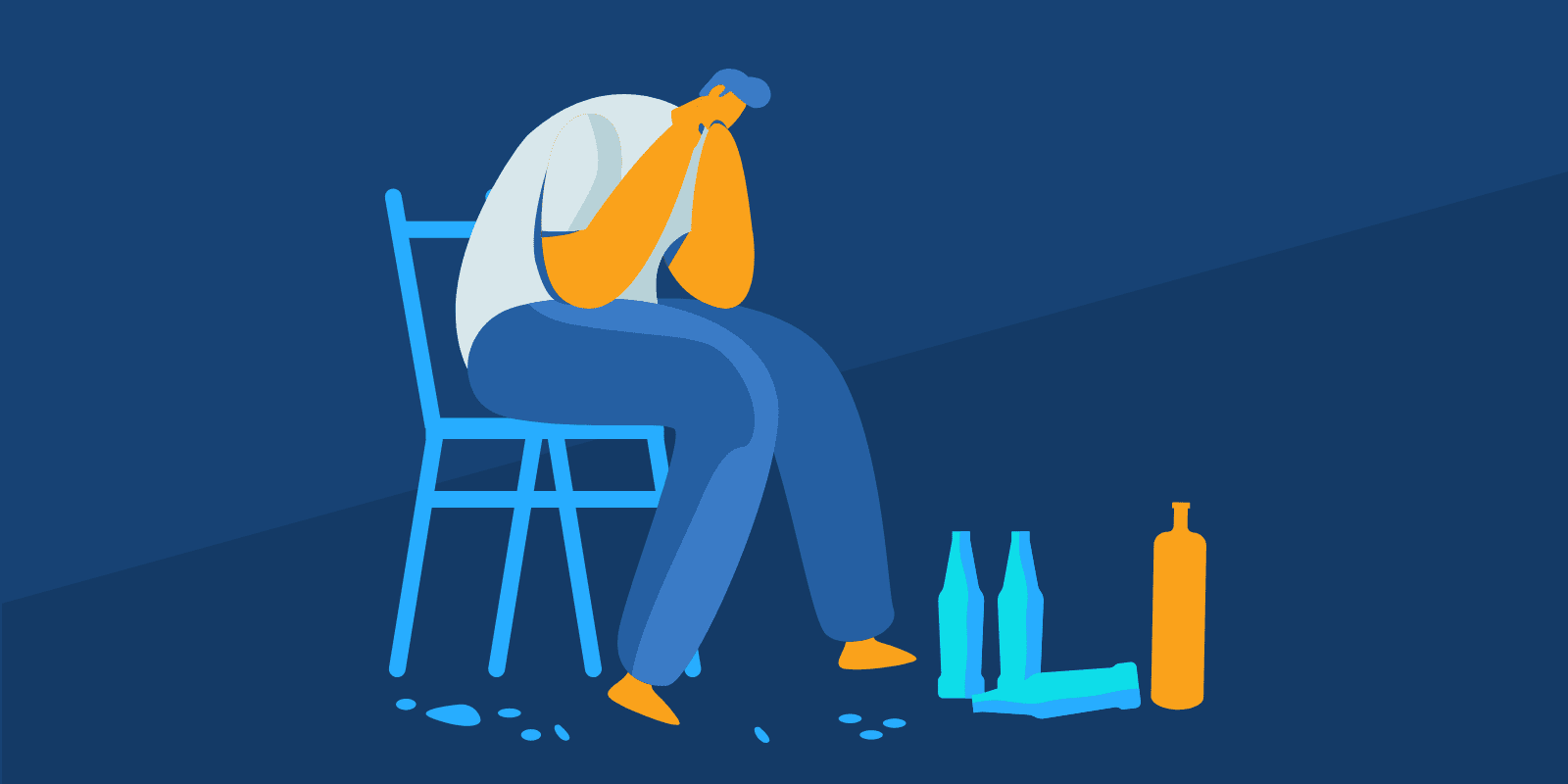 A person sitting in a chair looking stressed and there are alcohol bottles next to his feet.