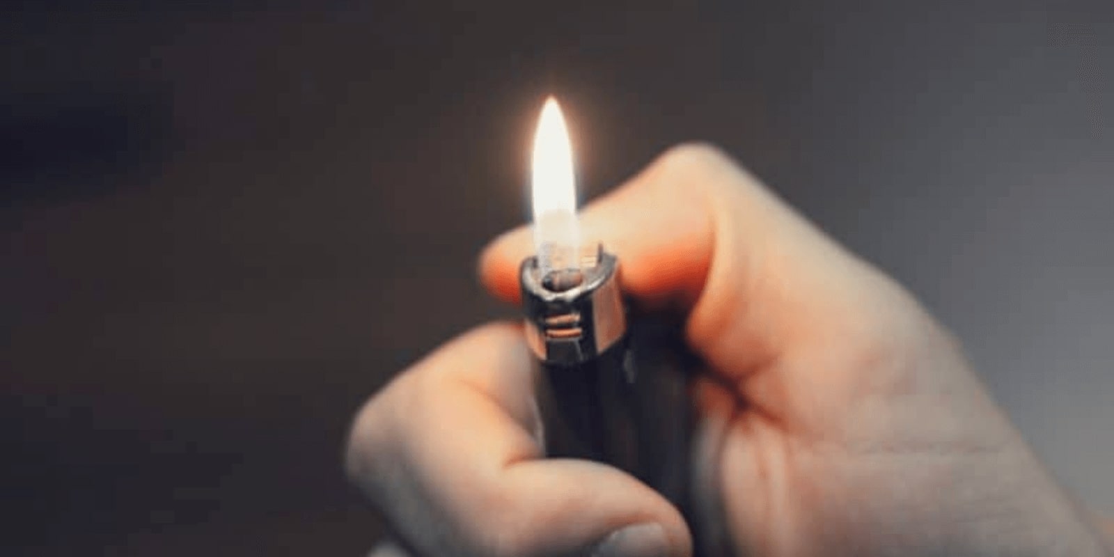 lighting up a lighter in the dark