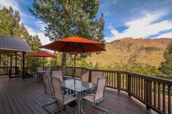 Sandstone Care's Colorado Teen Rehab's spacious deck with outdoor furniture overlooking mountains.