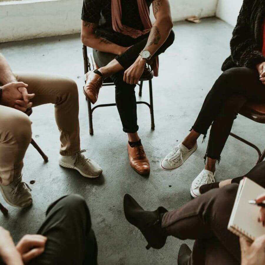 People Sitting In A Circle In Group Therapy