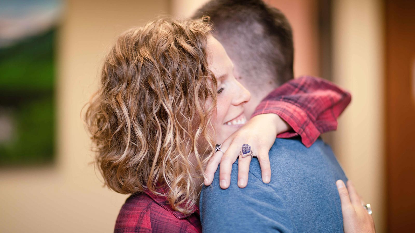 there is a man and woman hugging each other in a room