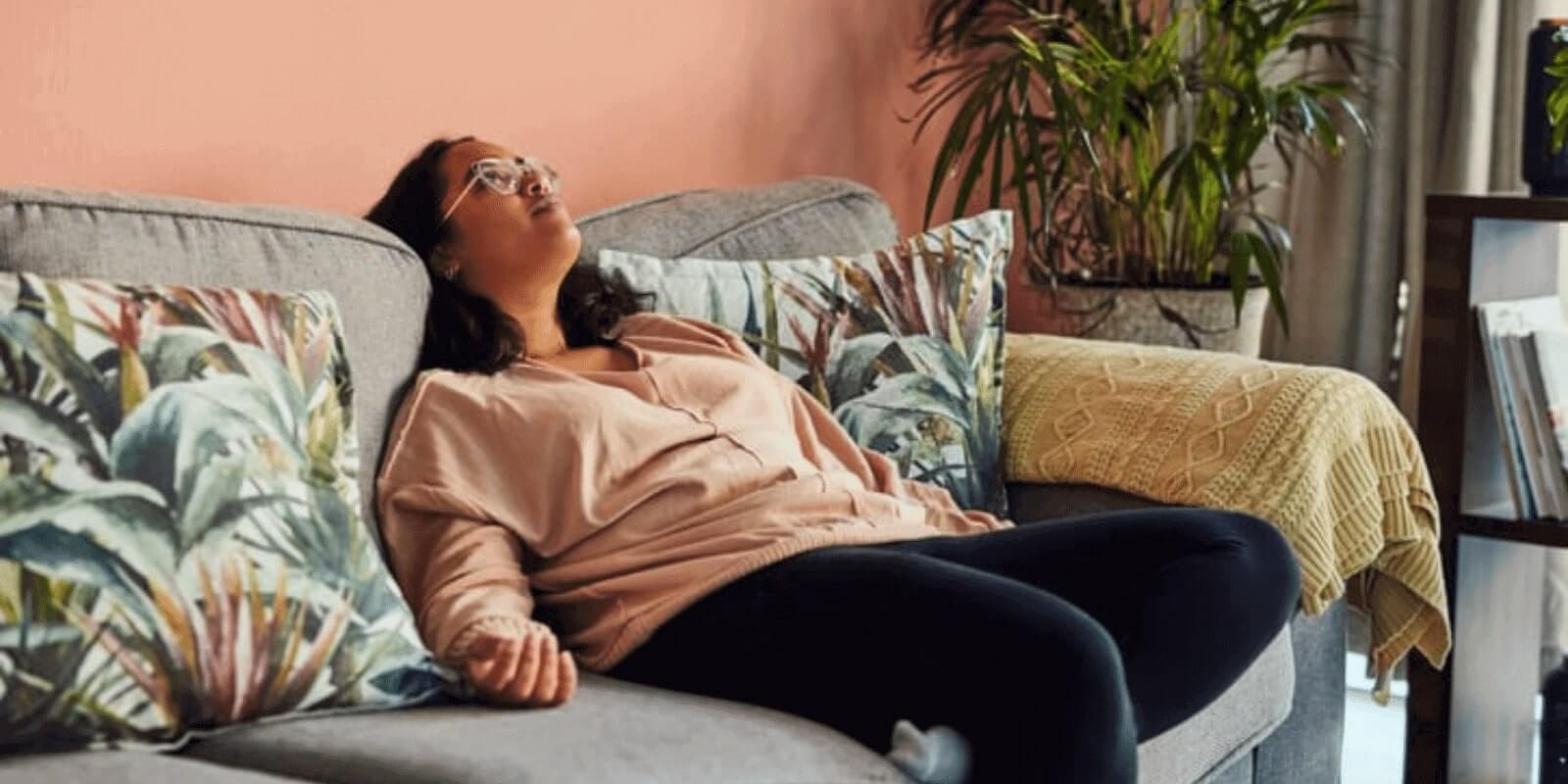 A young woman sunk in the sofa while looking up