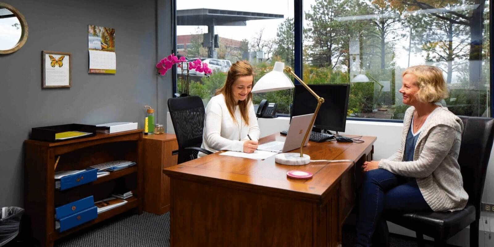 Mom talking to the therapist over the desk