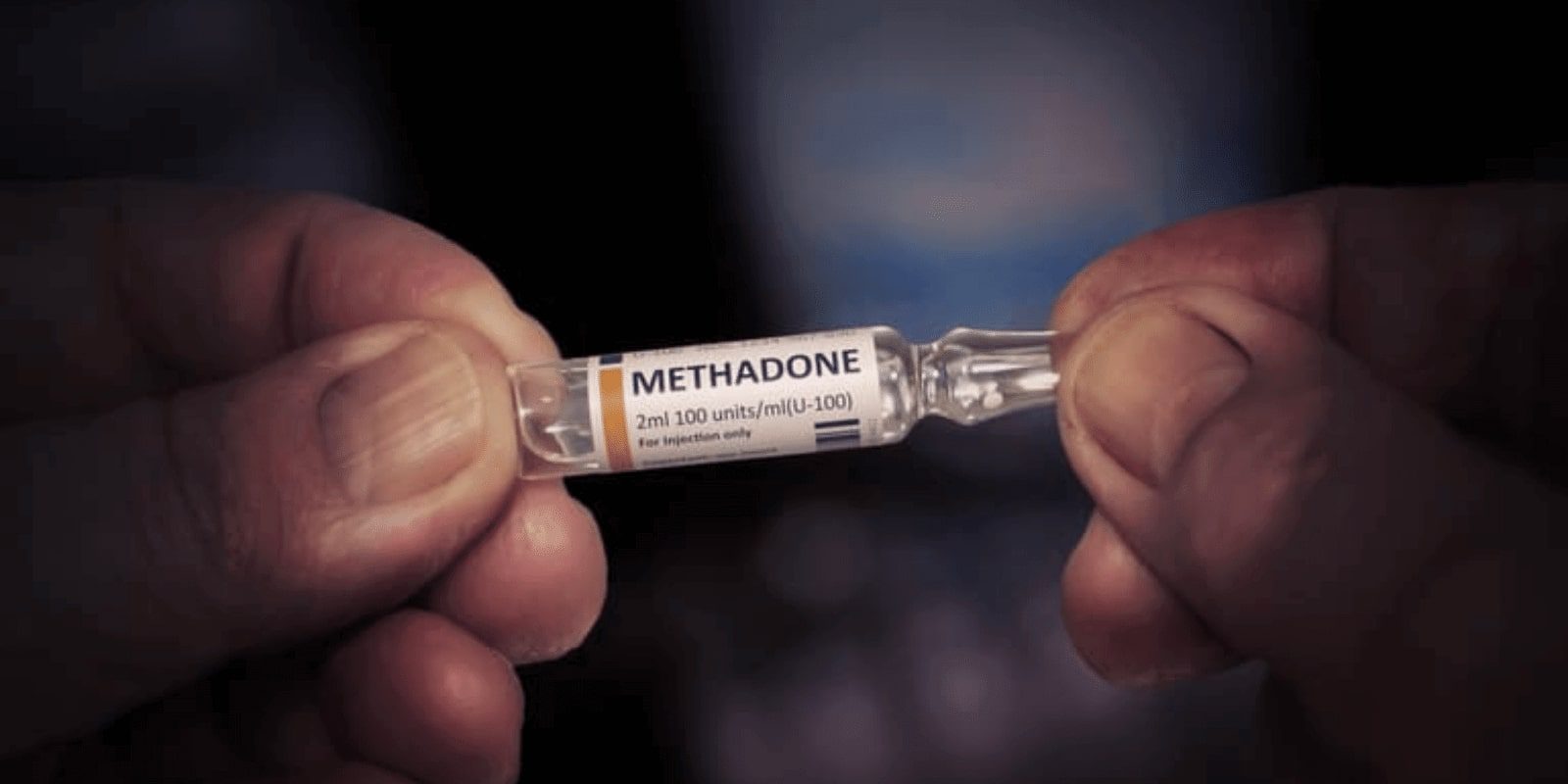 Hands holding methadone bottle