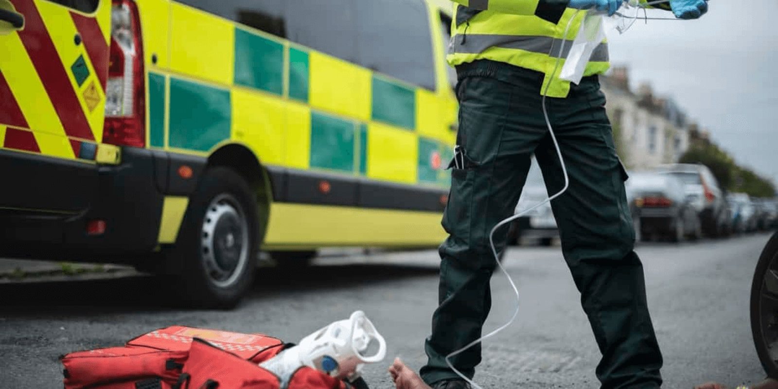 emt giving medicine to a patient on the street