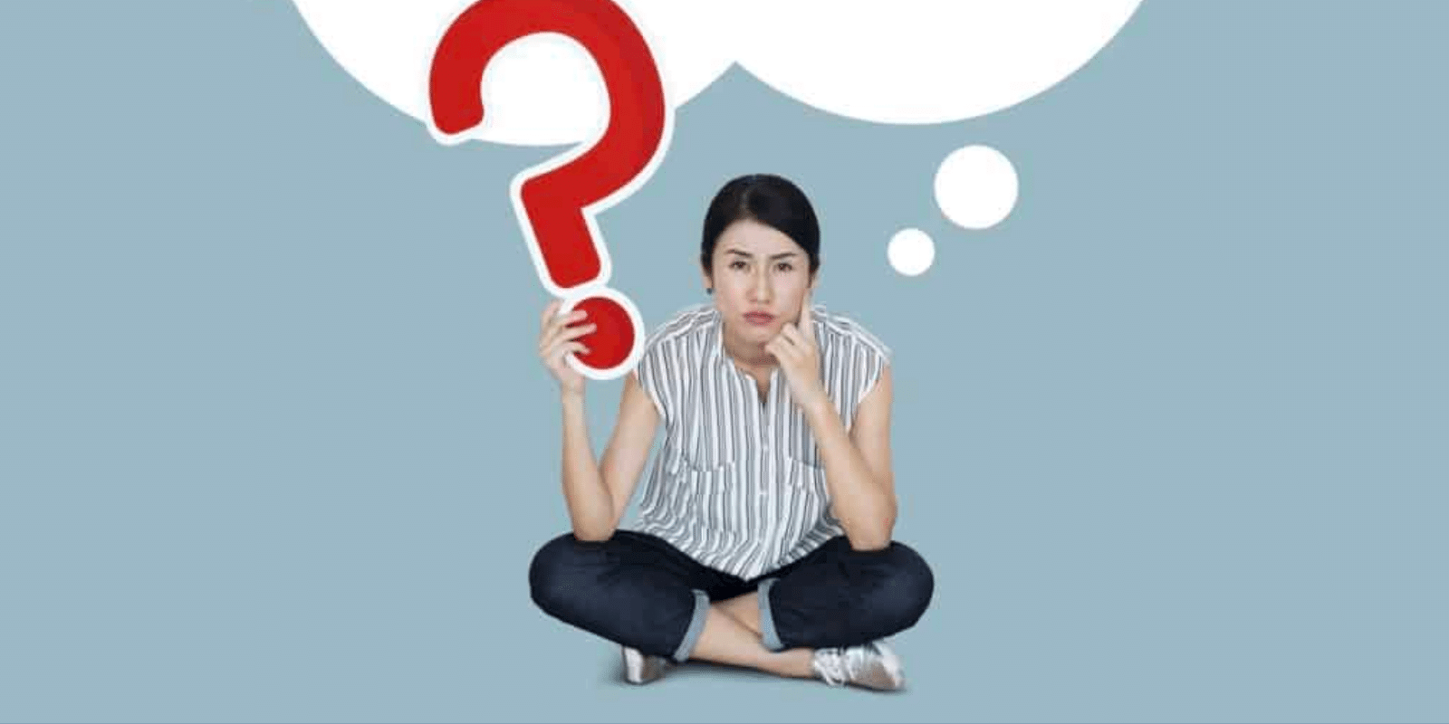 A woman holding question mark under a white empty thought bubble
