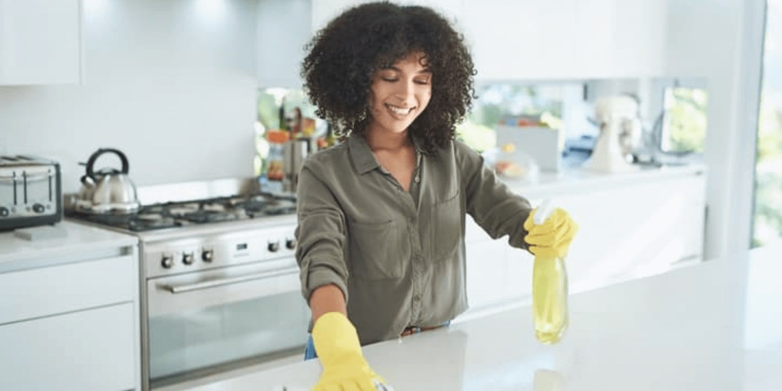 woman wiping down a clean countertop