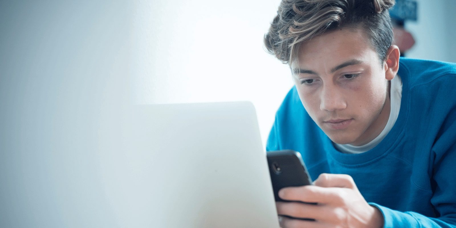 Teen boy on phone