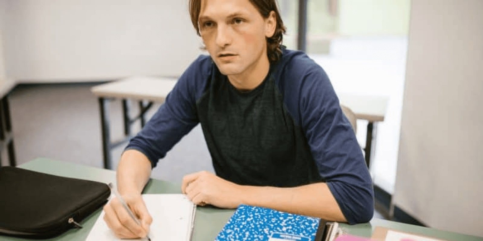 A teen boy doing homework