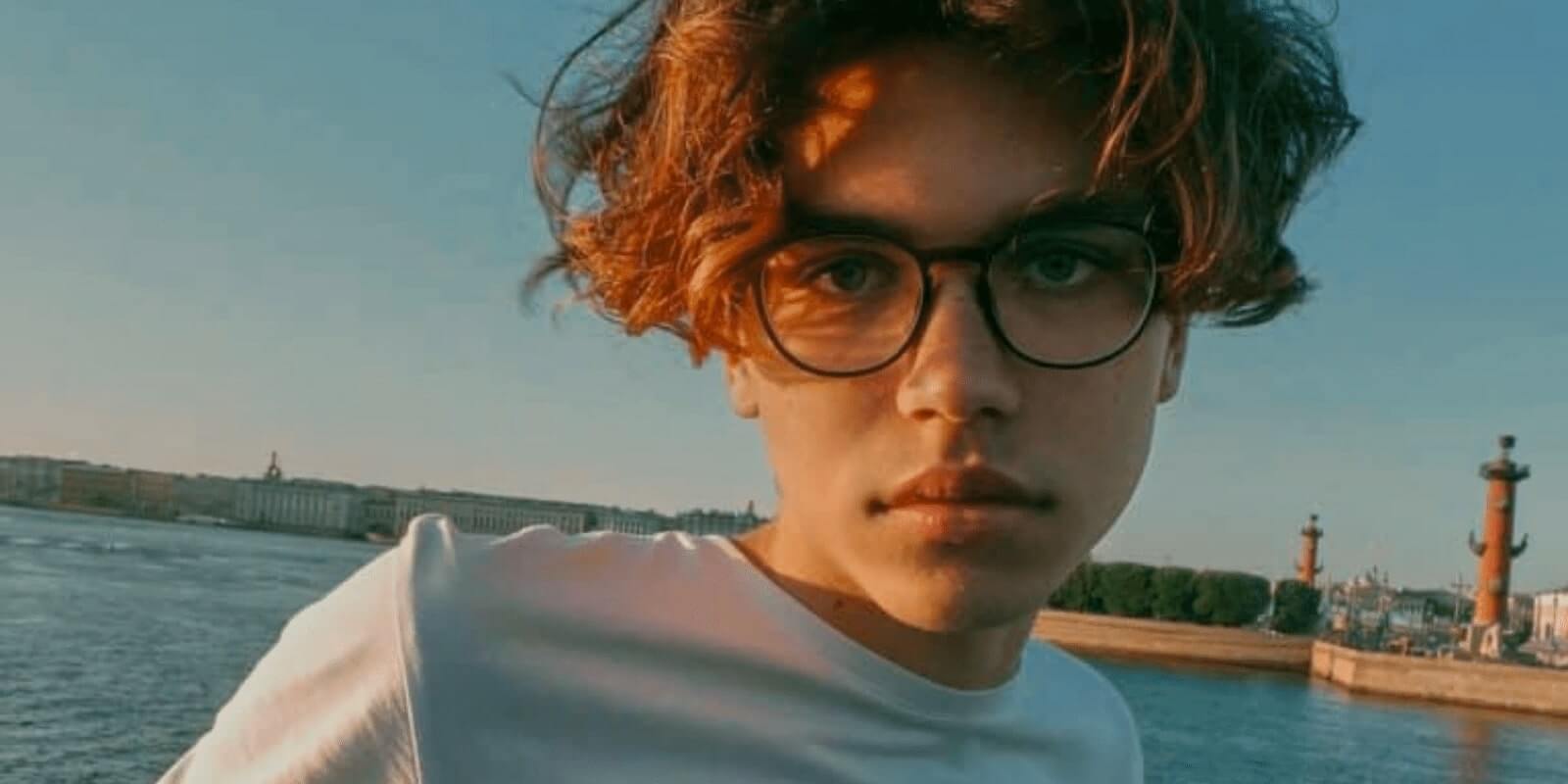 A teen boy in front of a beach