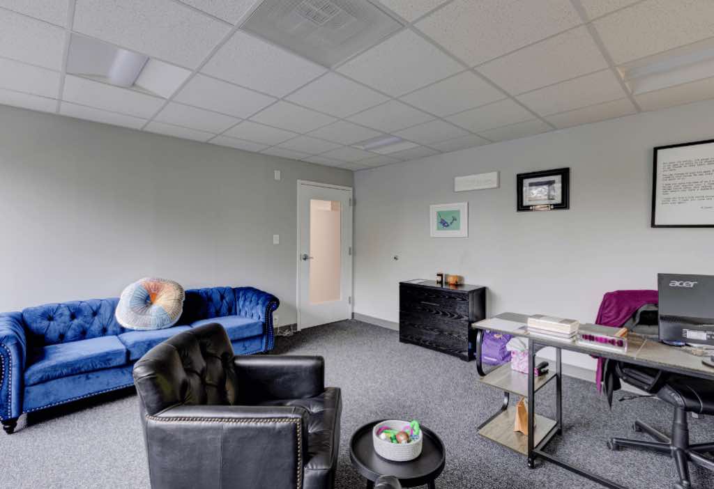 A blue couch in a cozy office at Towson rehab center