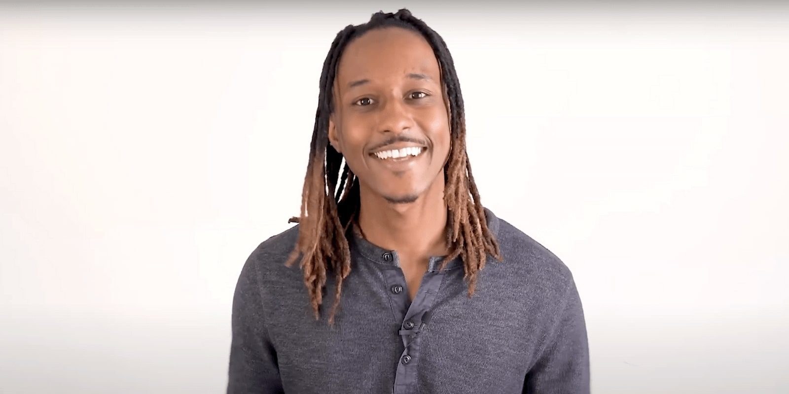 African American man smiling on a white background