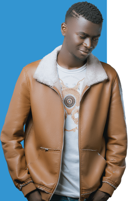 Young black man standing in front of a blue background.