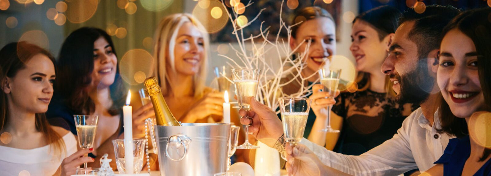 young adults gathered around table celebrating holidays