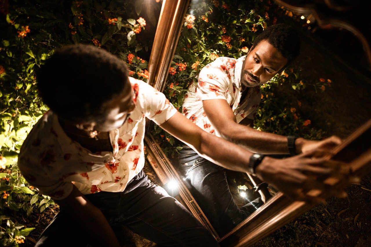 A man looking at the mirror in the garden