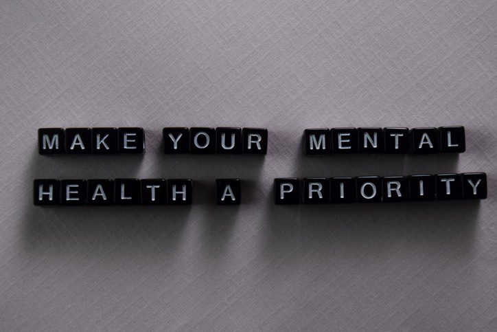 Make your mental health a priority on wooden blocks. Motivation and inspiration concept