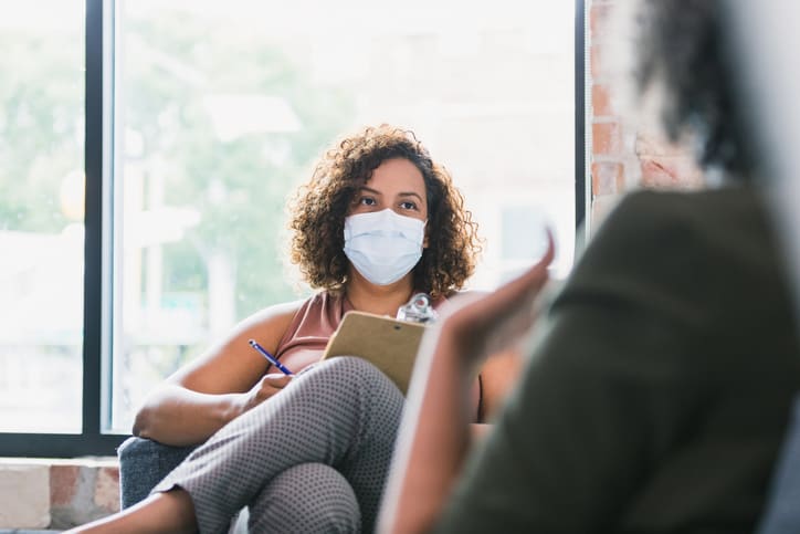 Female counselor wears mask during session