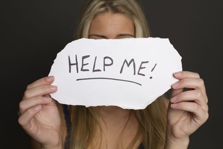 teen-suicide-prevention-girl holding help me sign