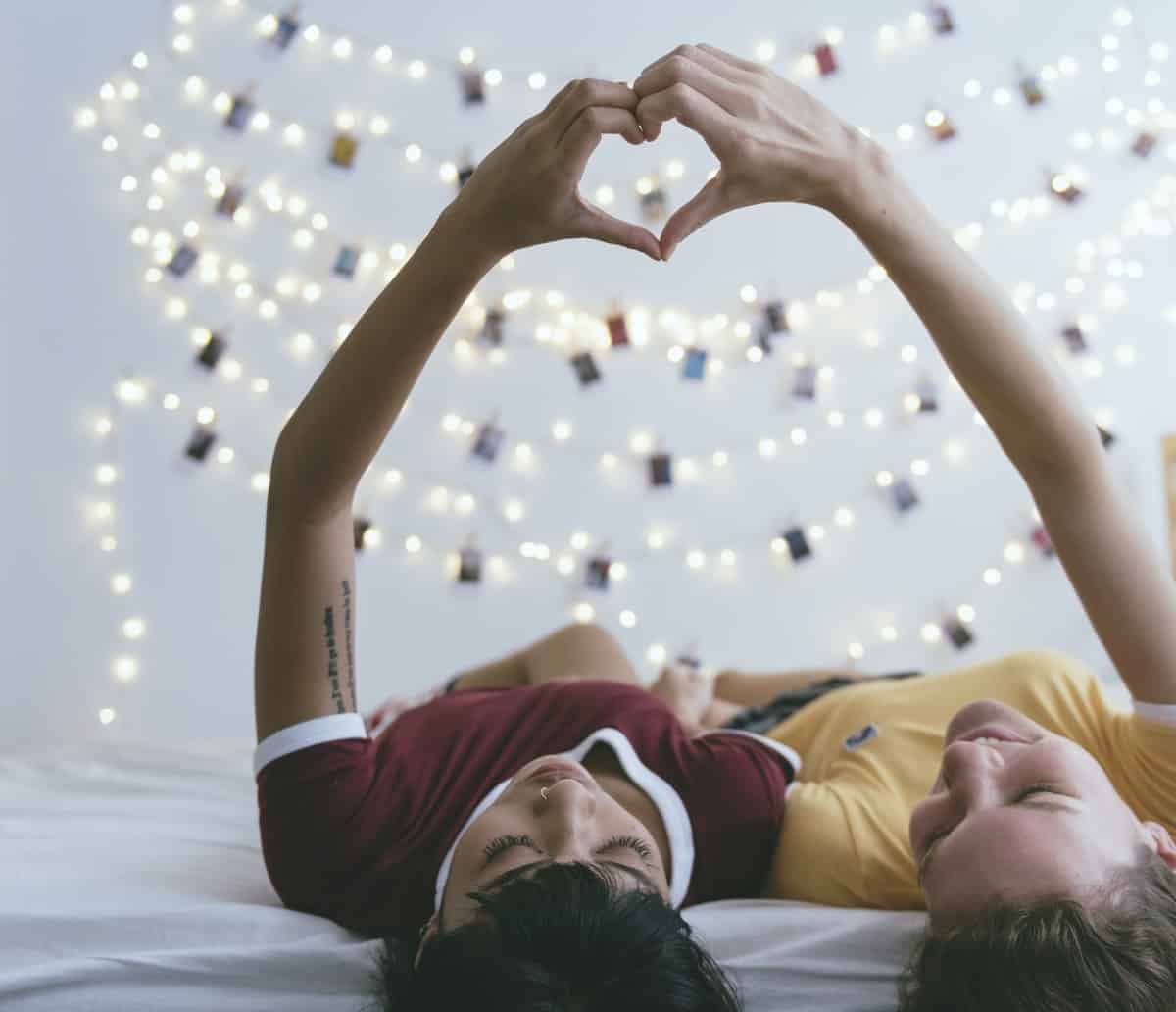 teens-making-heart-symbol-with-hand