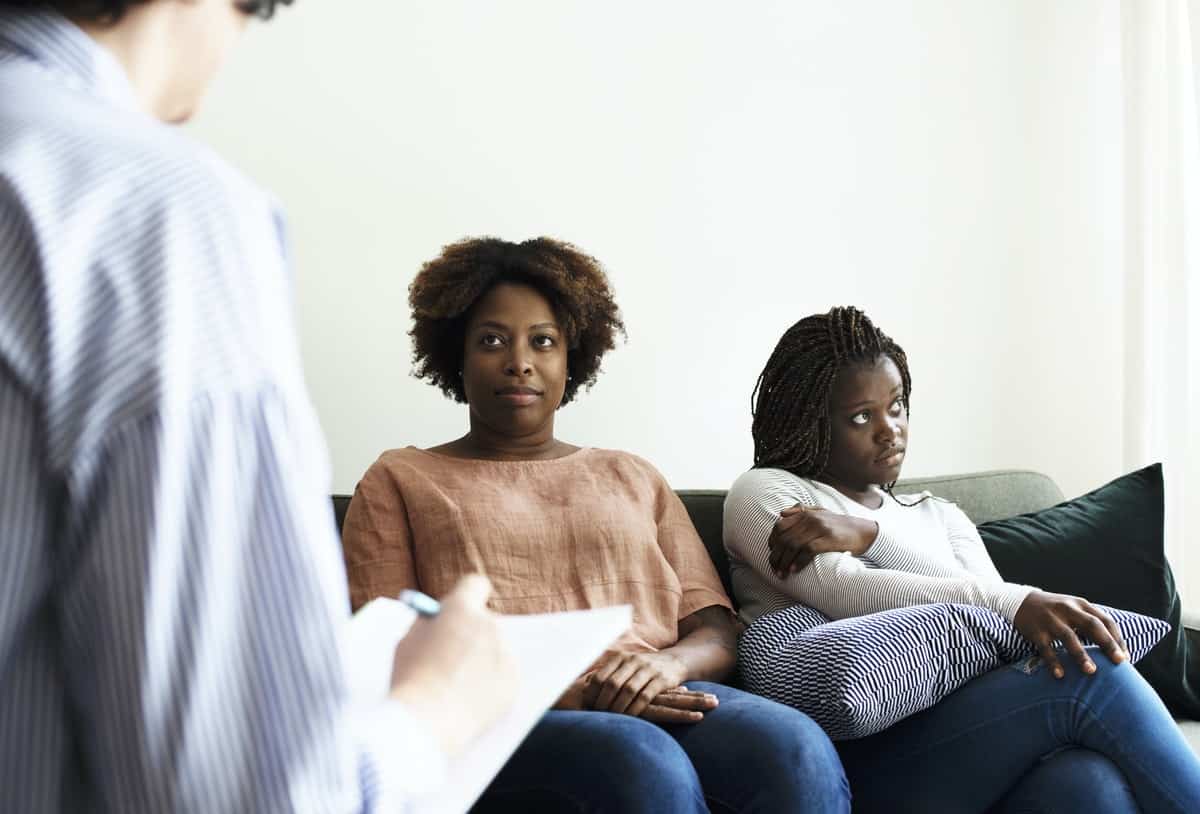 Mother and daughter meeting with a therapist