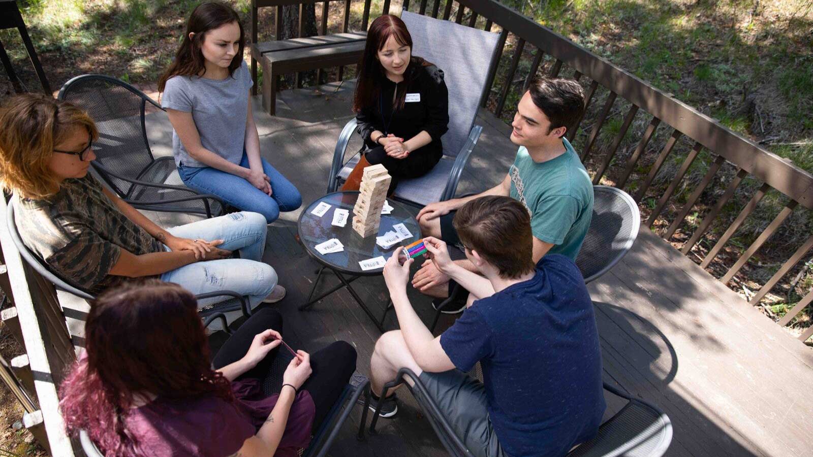 group of teens playing jenga and card games