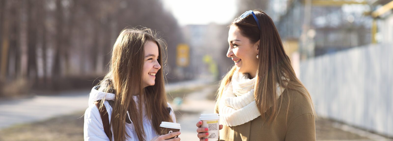 mother and daughter talking, outside