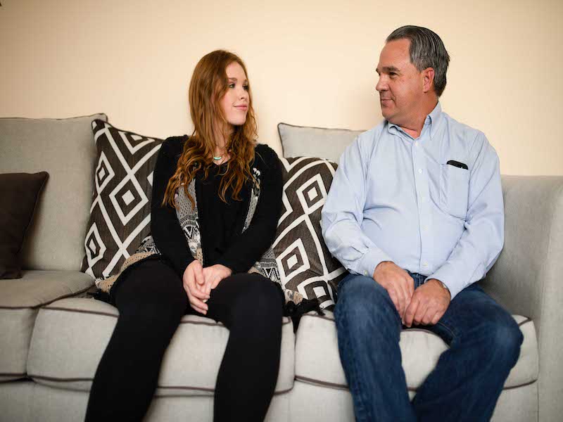 Father and daughter sitting on a therapy couch