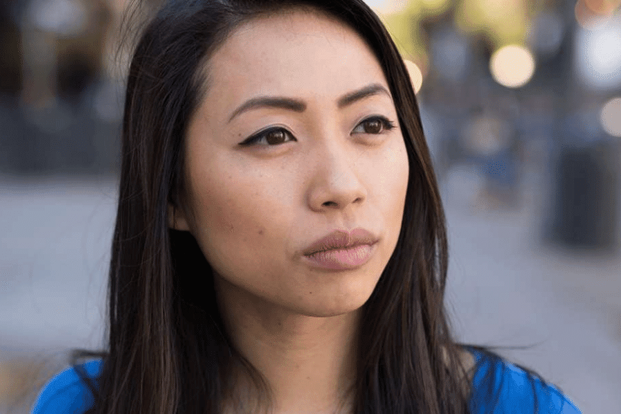 Young woman looking away in the street